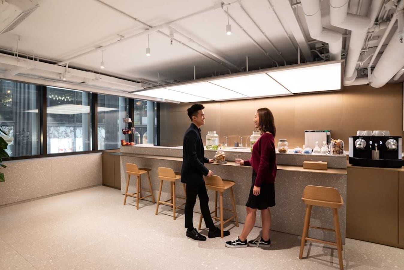 Sleek coworking lounge with modern seating and ample natural light on Connaught Road Central.