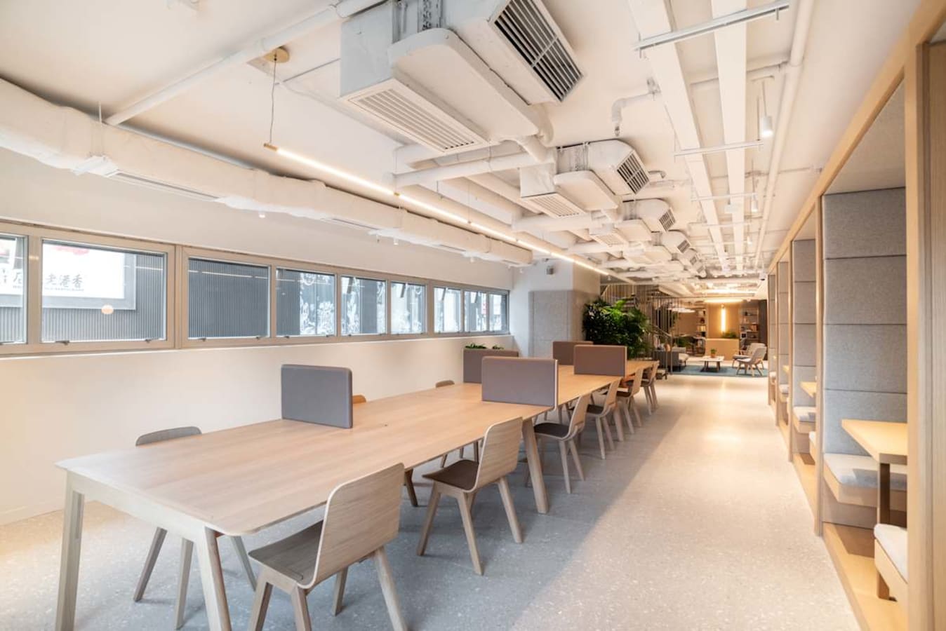 Bright coworking area with modern furnishings and ample natural light on Connaught Road Central.