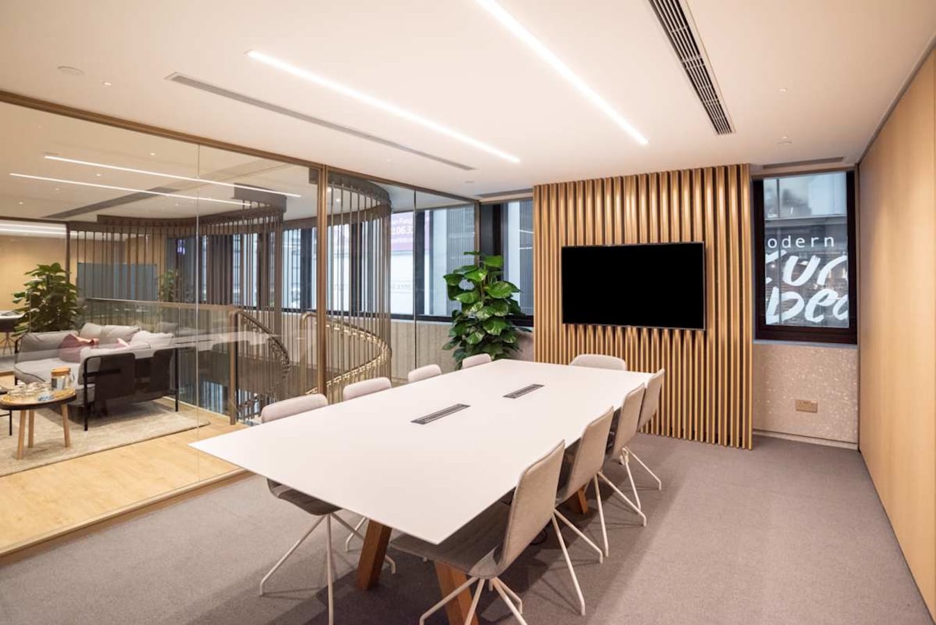 Modern coworking space on Connaught Road Central with sleek boardroom and open lounge area.