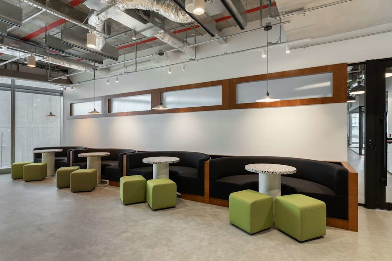 Modern coworking space with sleek seating, bright lighting, and a collaborative atmosphere.