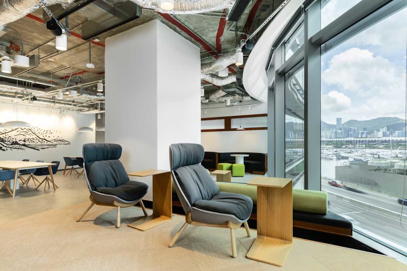 Modern coworking space with plush seating and stunning harbor views on Hoi Bun Road.