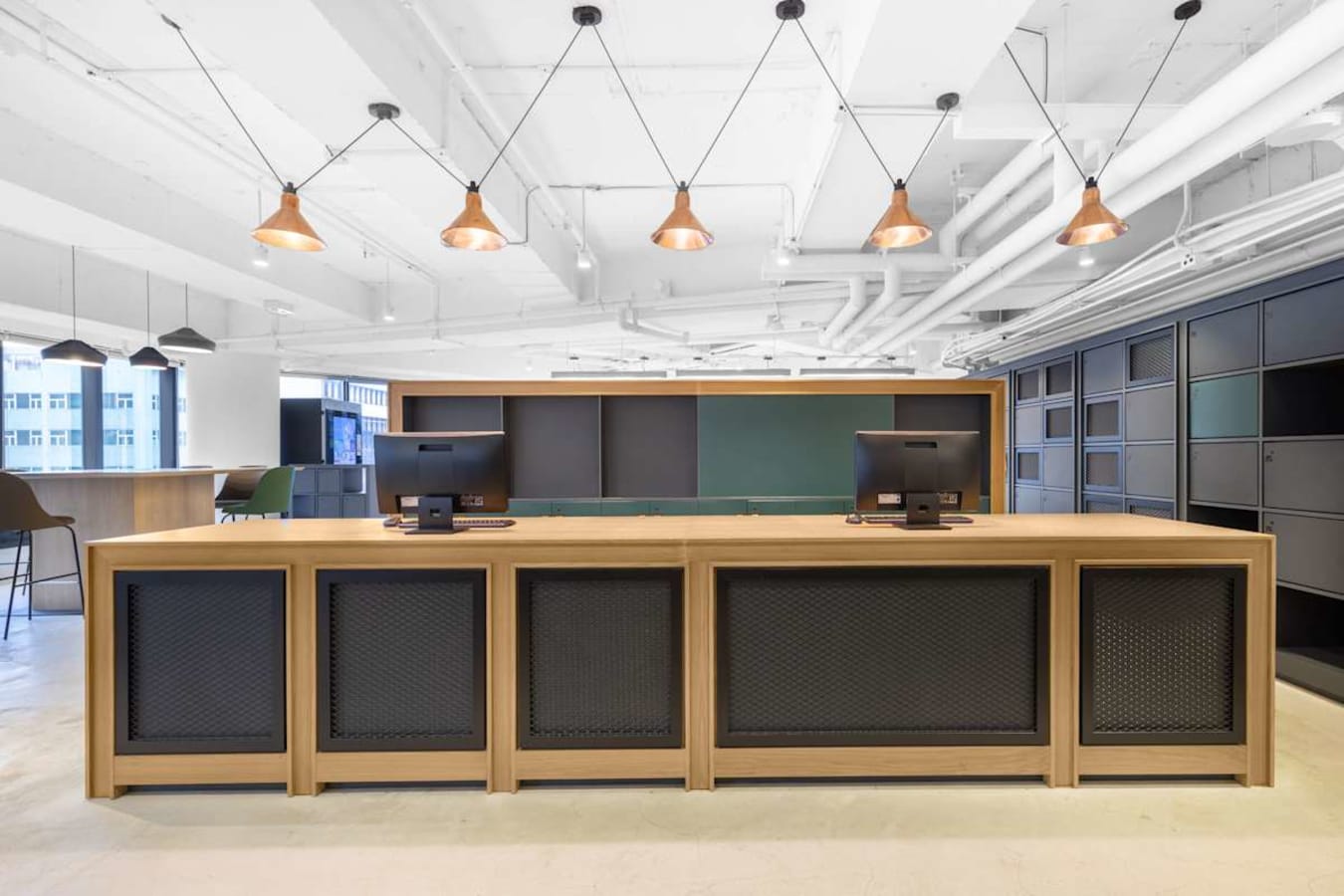 Sleek coworking space with modern desks and stylish lighting on Nathan Road. Ideal for dynamic teams.