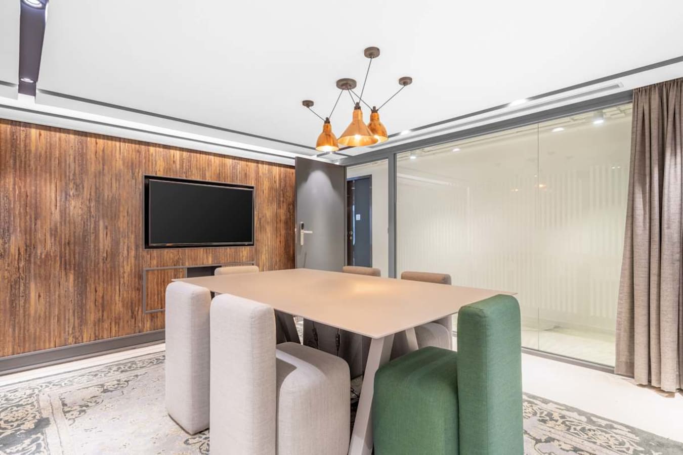 Modern meeting room with sleek design, soft seating, and ample natural lighting. Ideal for collaboration.