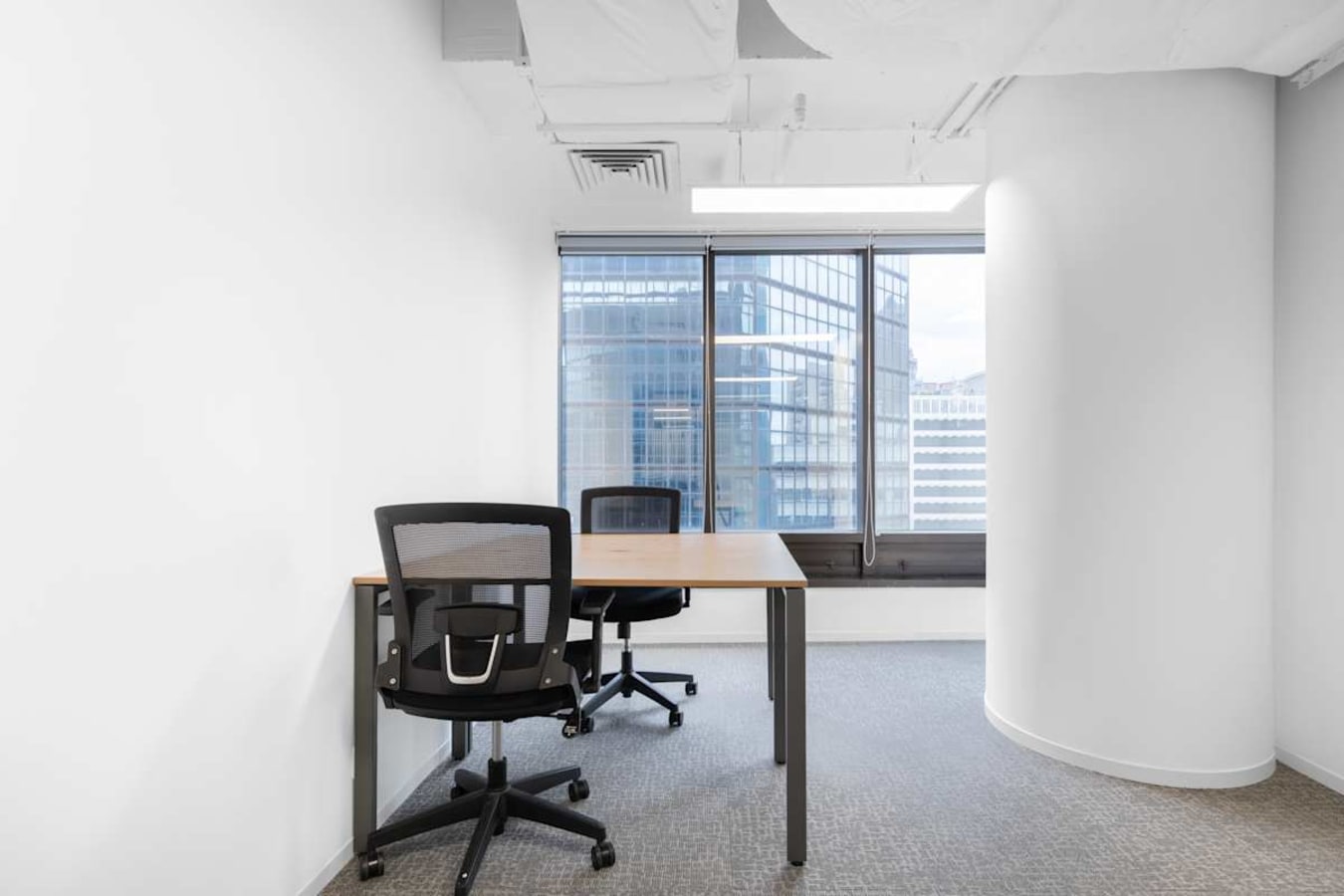 Bright, minimalist coworking space with window views on Nathan Road. Ideal for focused work.