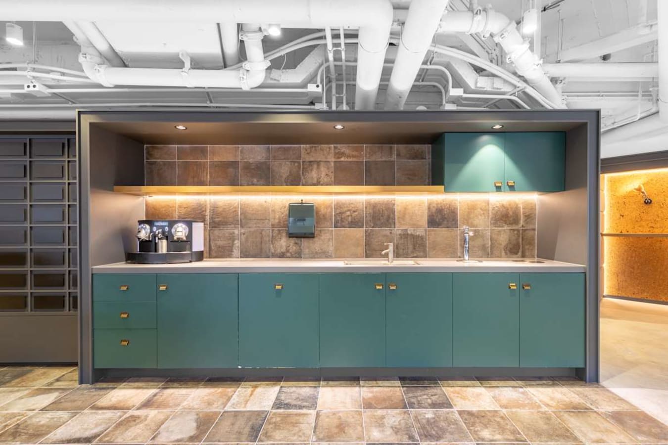 Modern kitchenette in a Nathan Road coworking space with sleek cabinetry and ample lighting.