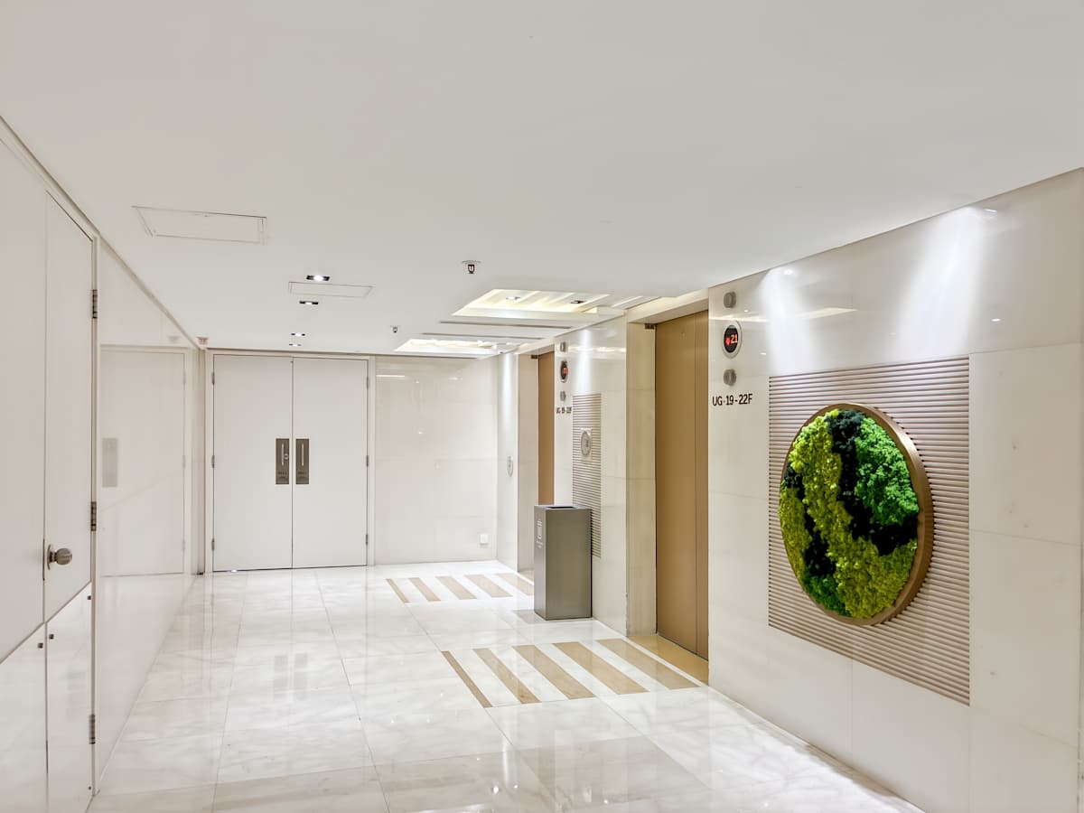 Sleek and modern entrance with polished flooring and green accent wall at Canton Road coworking space.