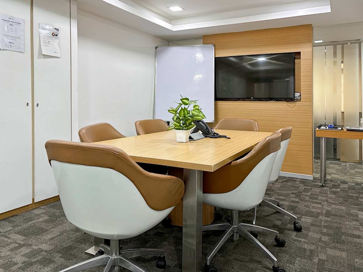 Modern Delhi coworking space with a sleek conference area, comfortable seating, and bright lighting.