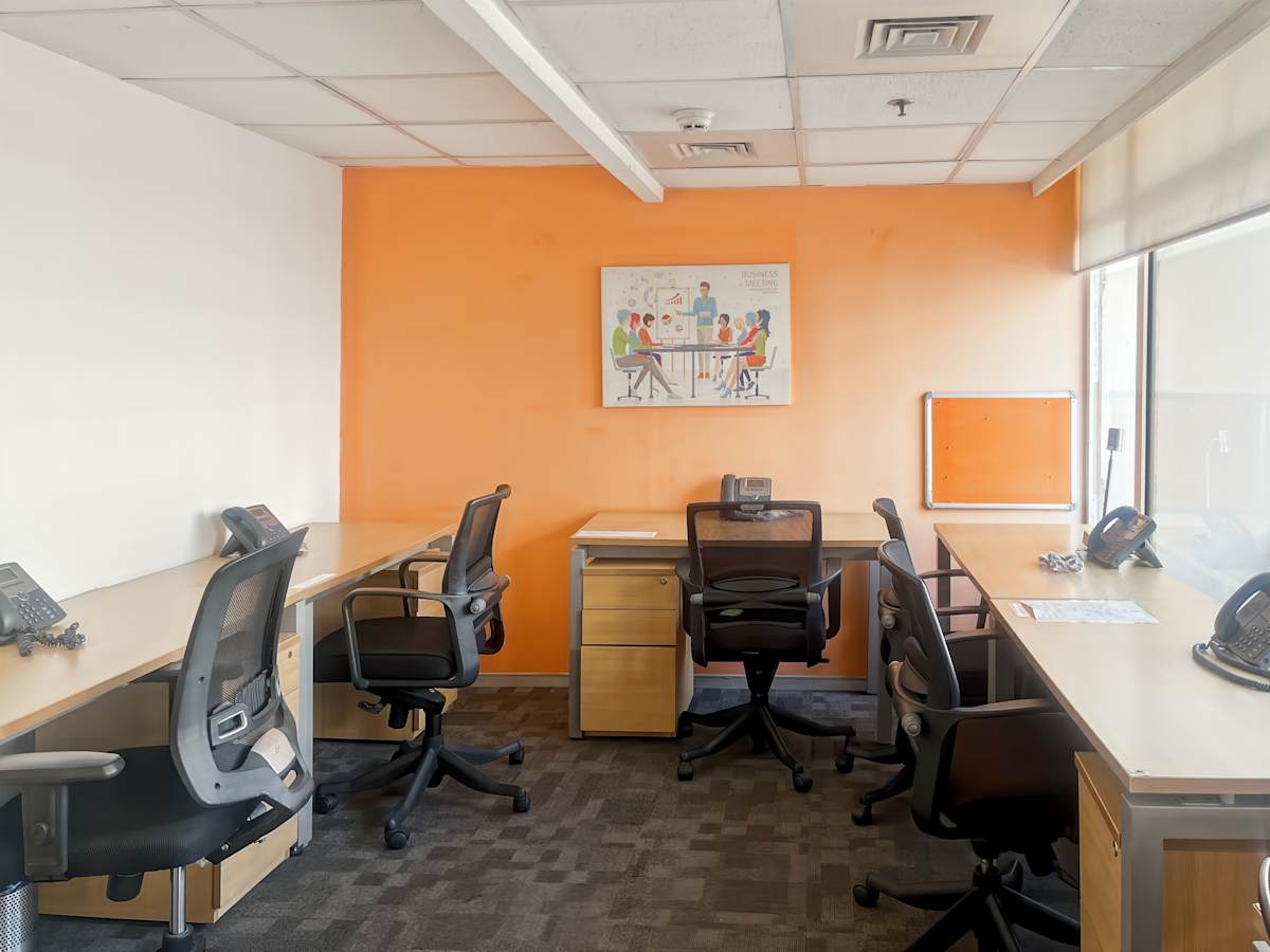 Bright, modern coworking office with ergonomic chairs and ample natural light in New Delhi.