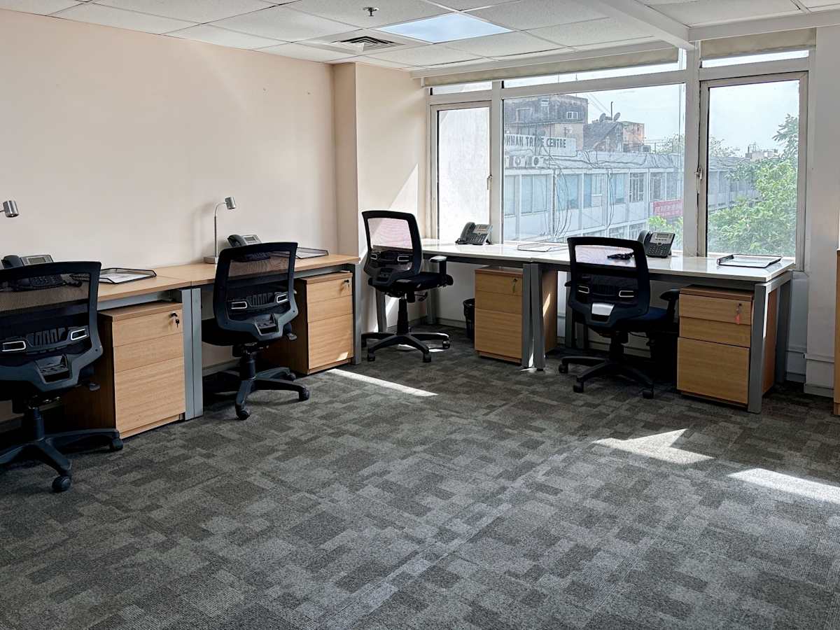 Bright coworking space with ergonomic chairs, ample desks, and natural light in New Delhi.