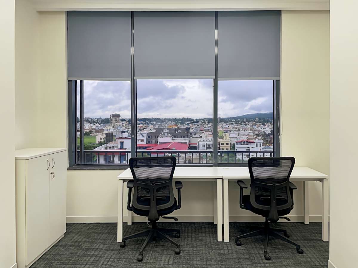 Bright coworking space with city views, ergonomic chairs, and ample natural light.