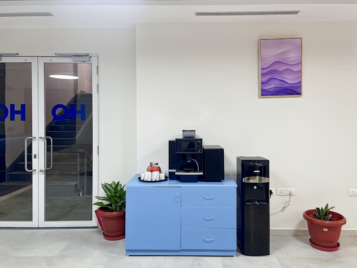Modern Haridwar coworking space with coffee station, vibrant decor, and natural light.