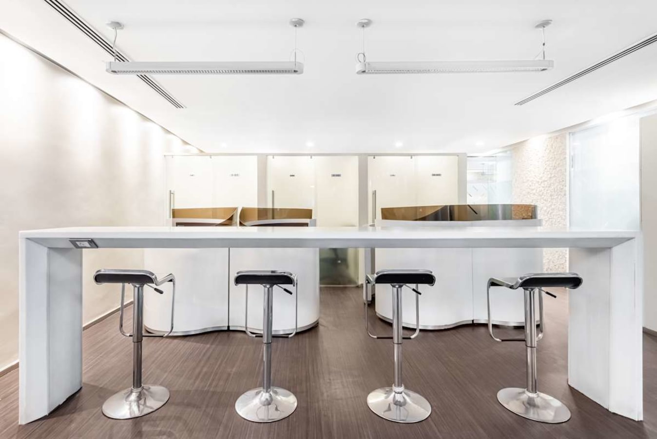 Sleek coworking area with modern high-top seating, ample natural light, and stylish finishes.