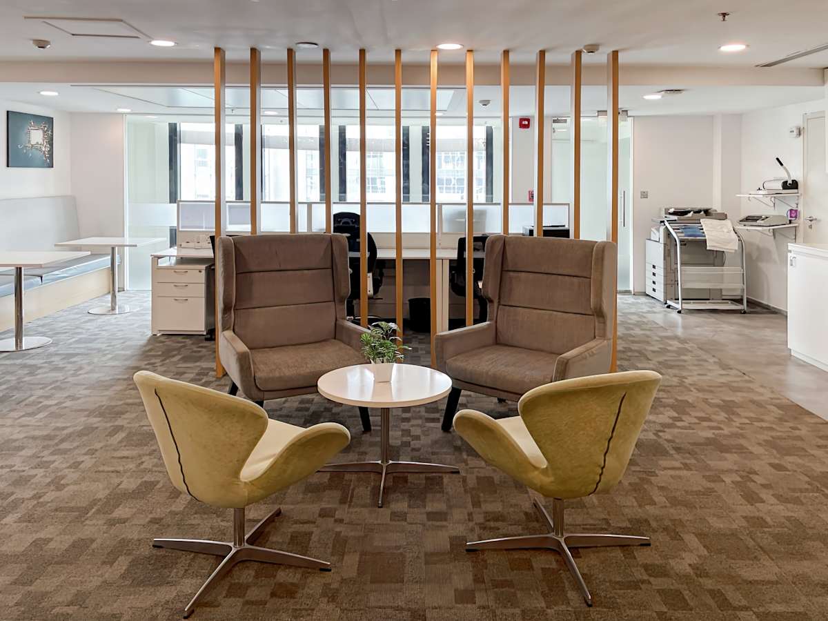 Modern coworking space with cozy seating, open layout, and natural light in Northern Access Road, Delhi.