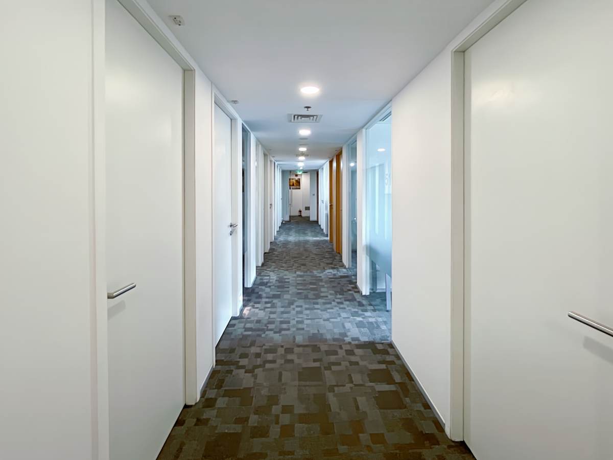 Bright, modern corridor with private offices in a flexible coworking space, Delhi.