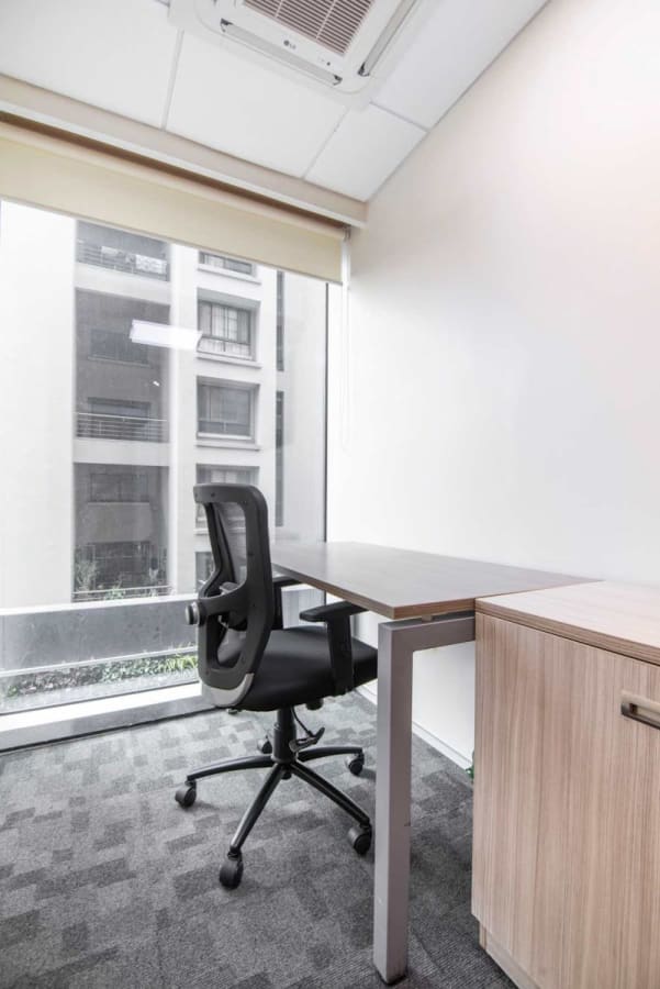 Modern private office with natural light, ergonomic chair, and spacious desk in Lane Number 7.