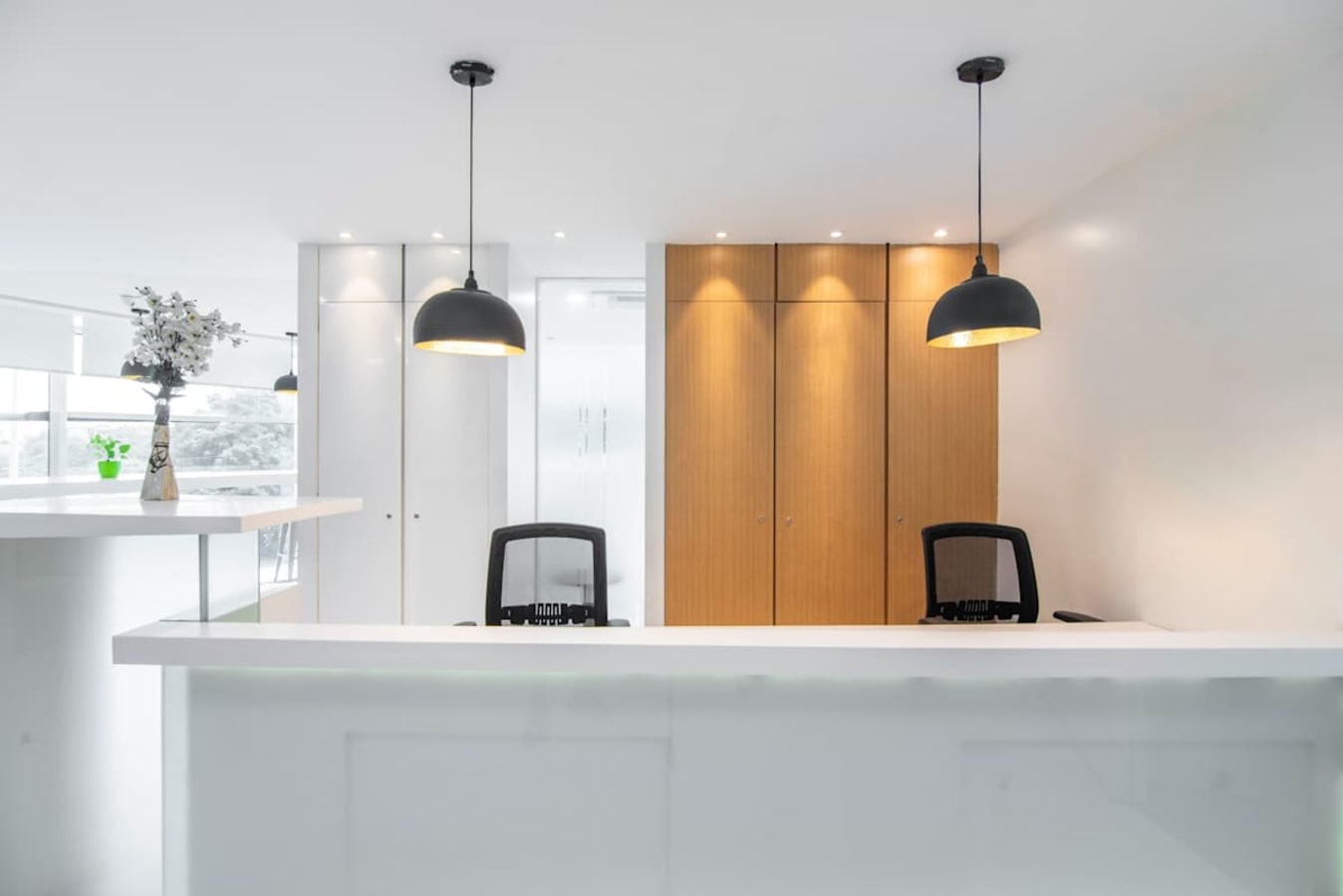 Modern coworking space with sleek design, ample lighting, and a welcoming reception area.