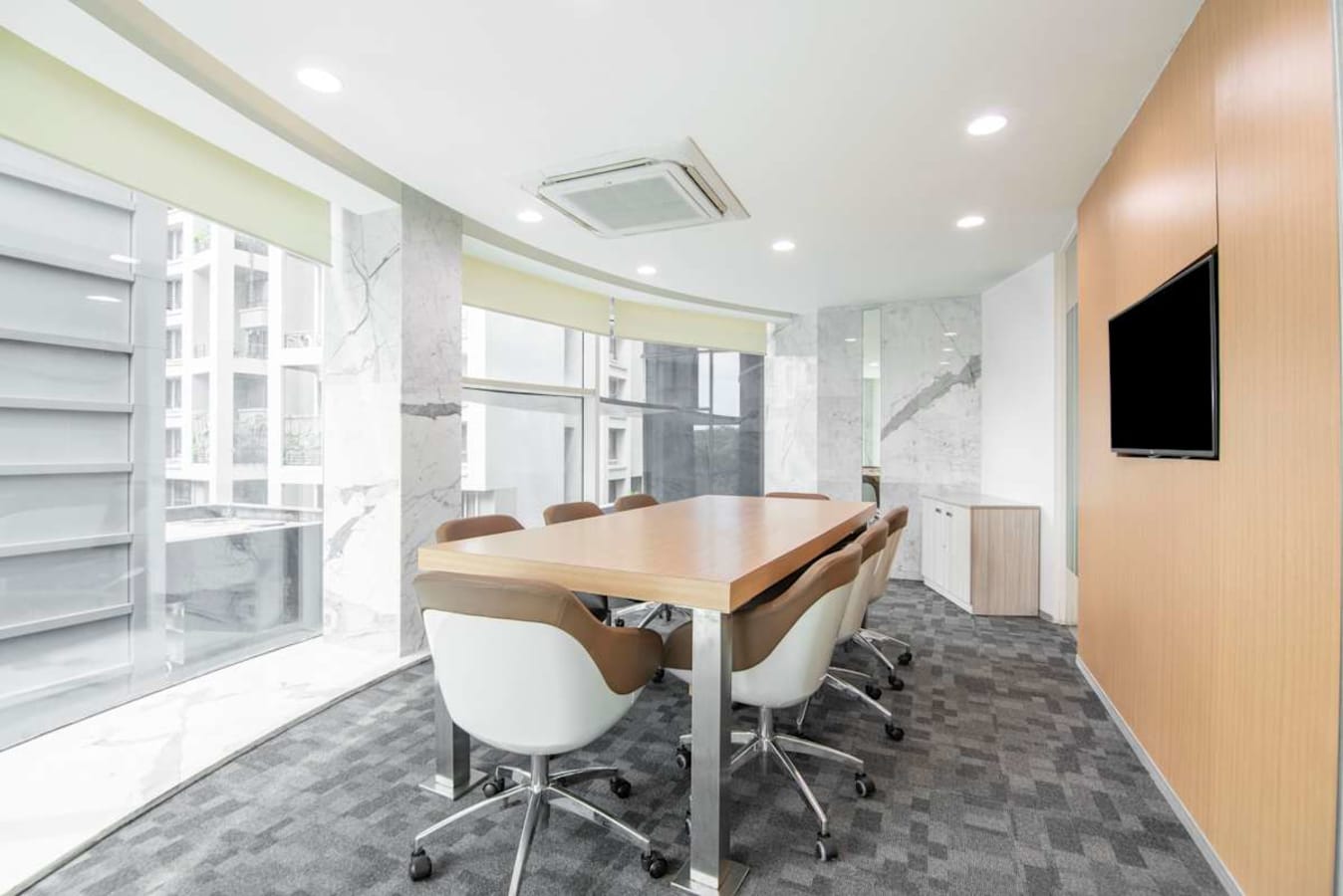 Modern coworking space with natural light, sleek design, and comfortable seating in Maharashtra.