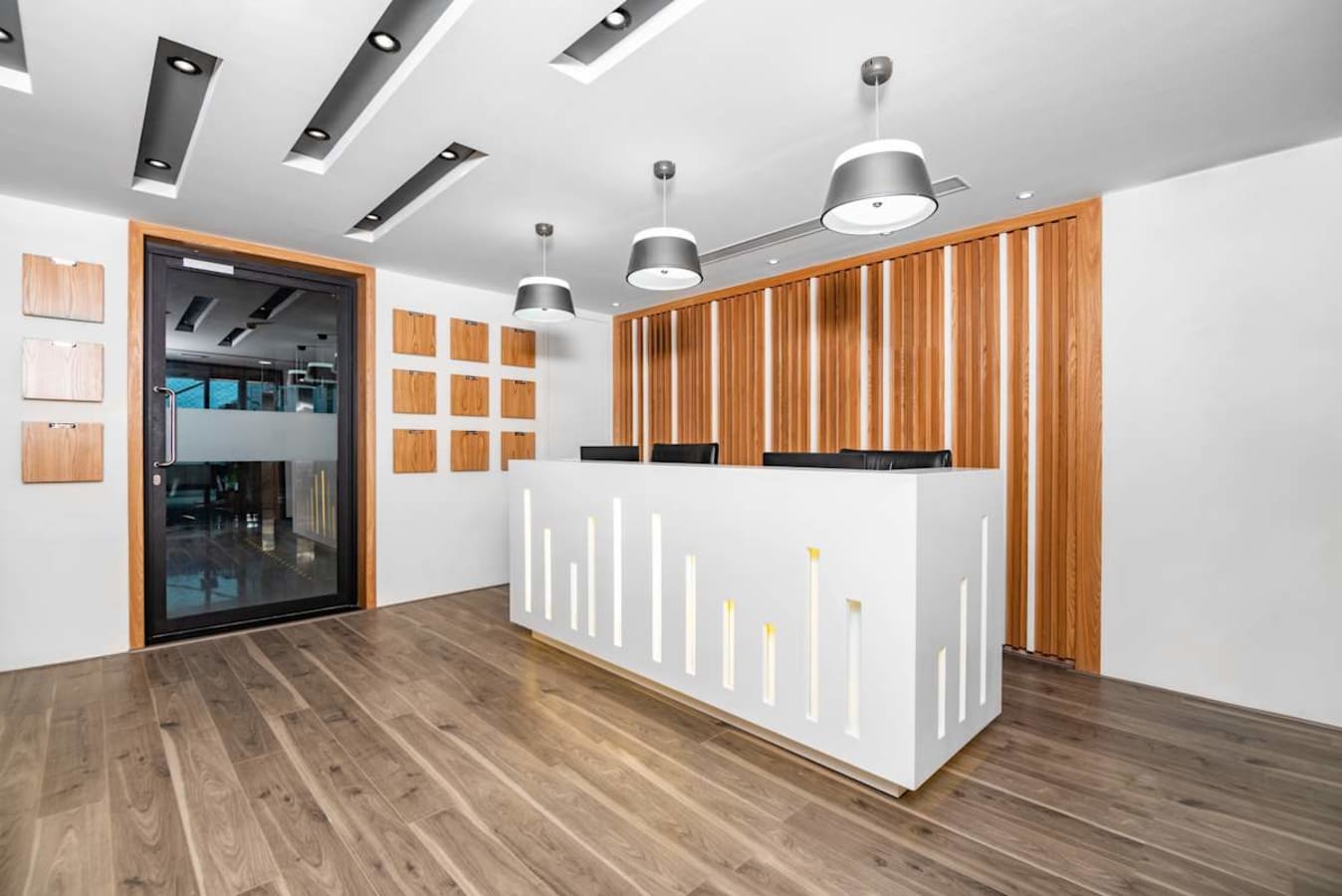 Modern reception area with sleek wooden accents and stylish lighting in Bandra Kurla Complex.