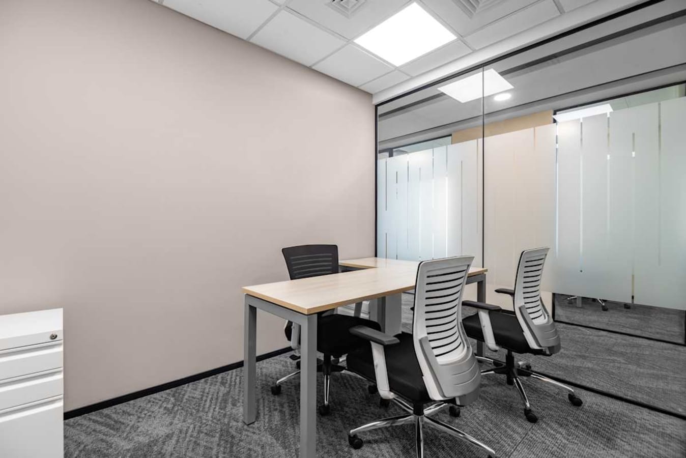Modern coworking space with sleek desks, ergonomic chairs, and ample natural light in BKC.