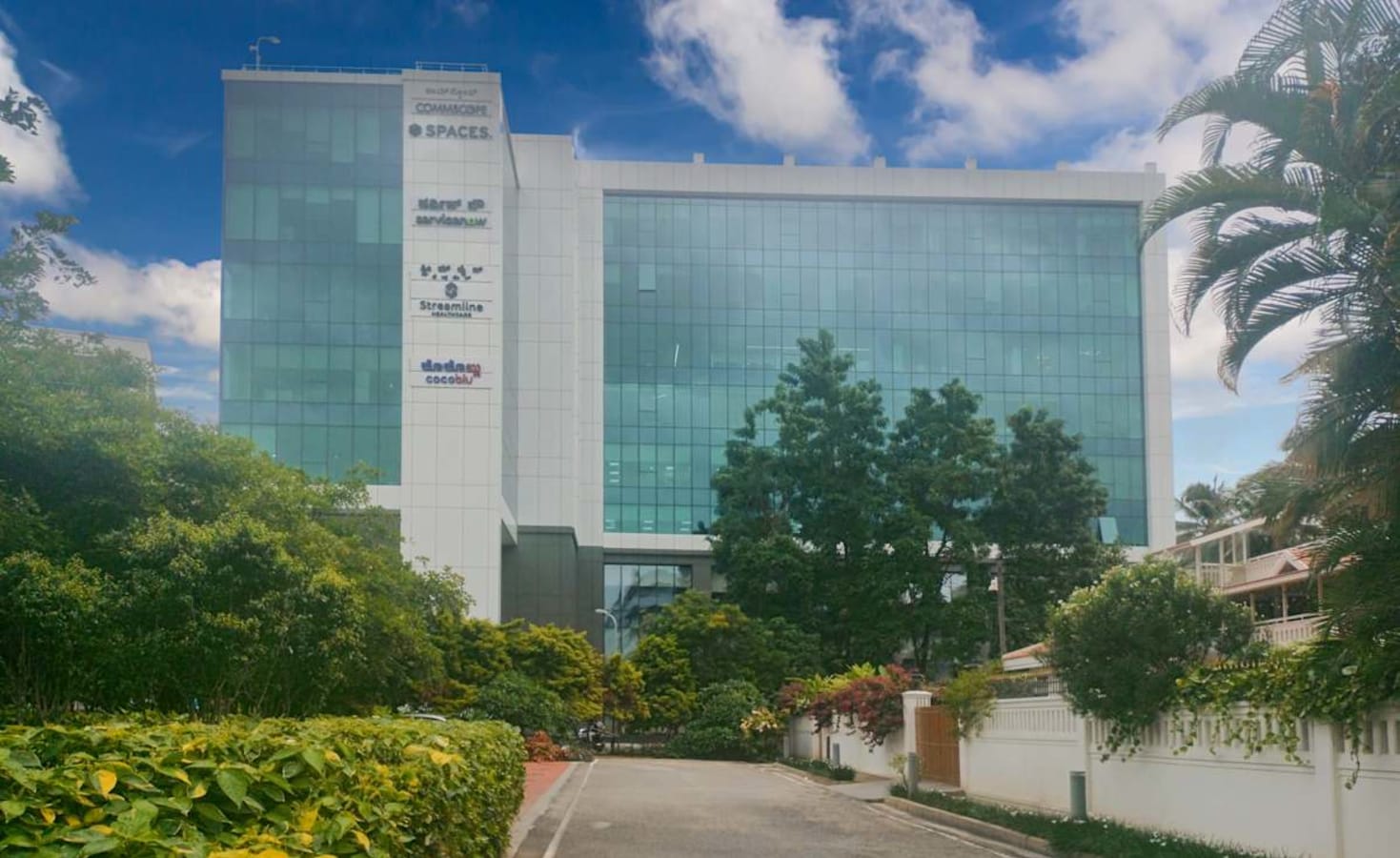Modern coworking space at Embassy Golf Links Road featuring sleek architecture and lush surroundings.