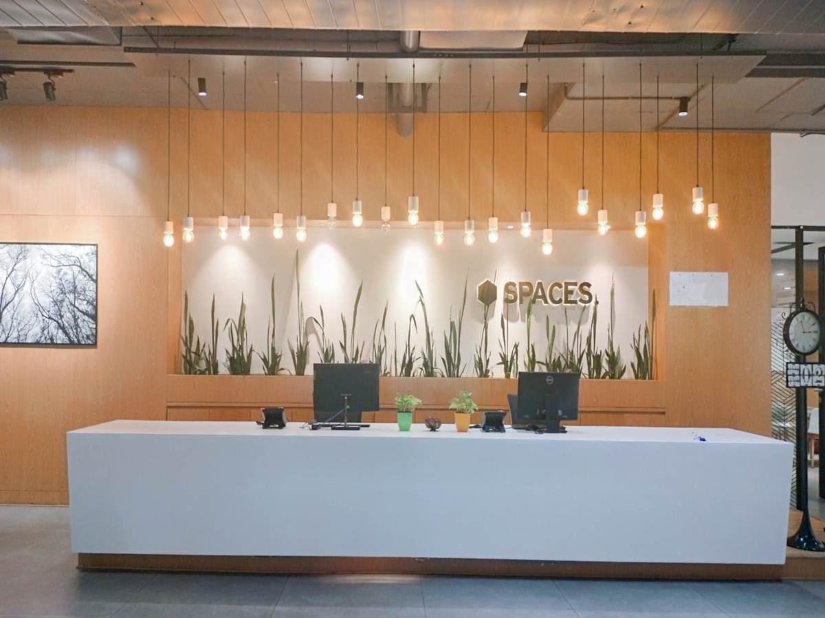 Modern coworking space with sleek reception, warm lighting, and inviting decor. Ideal for professionals.