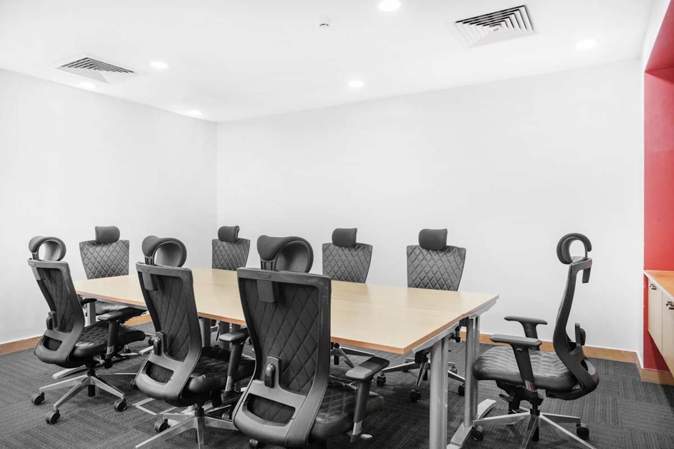 Modern meeting room with ergonomic chairs and sleek conference table in prime coworking space.