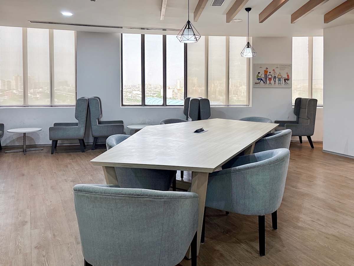 Bright coworking area with modern seating and natural light in Sale Shop, Uttar Pradesh.