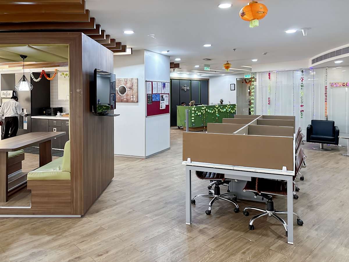 Modern flexible workspace with open seating, private booths, and a vibrant, welcoming atmosphere.
