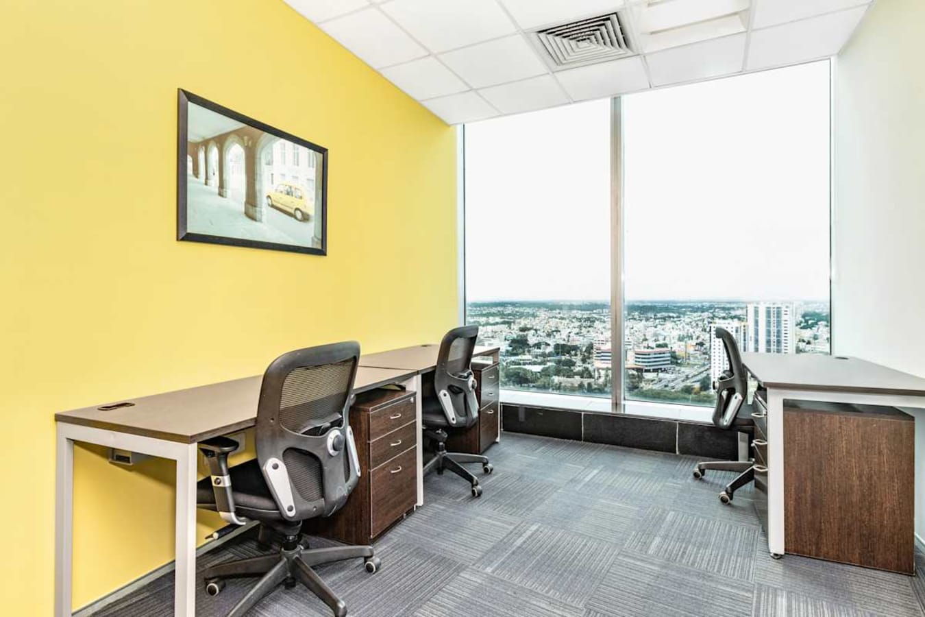 Bright, flexible workspace with city views, modern desks, and ergonomic seating.