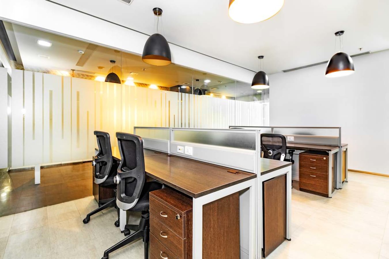 Modern coworking space with ergonomic chairs, wooden desks, and stylish lighting.