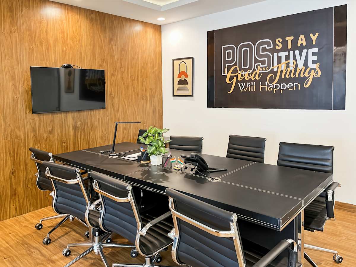 Sleek conference room with modern seating and motivational decor in a flexible coworking space.