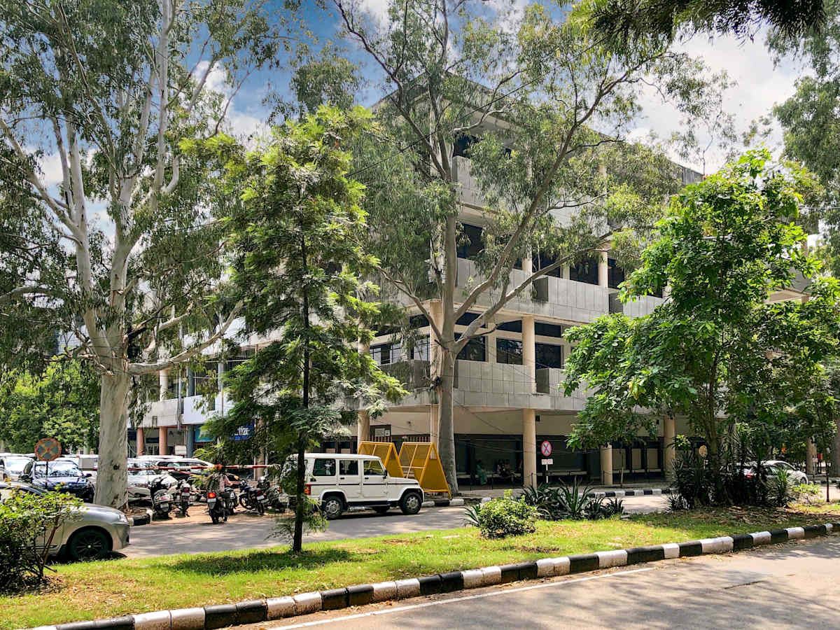 Modern coworking space in Sector 17A, Chandigarh, surrounded by lush greenery.