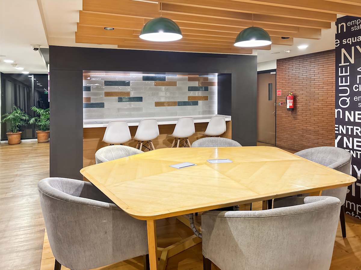 Modern coworking space with sleek wood finishes, stylish seating, and vibrant lighting in Sector 17A.
