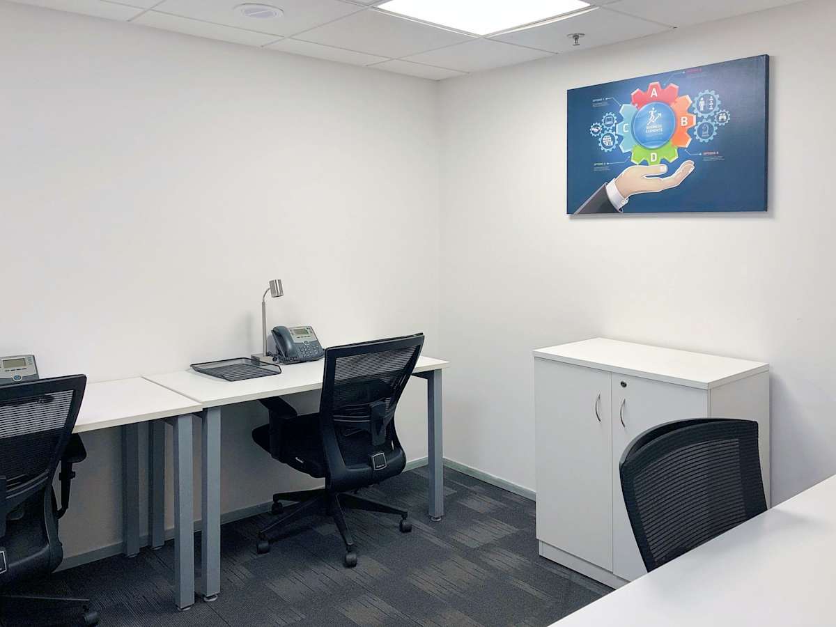 Modern coworking space with ergonomic chairs, dual desks, and ample natural light in Sector 17A.
