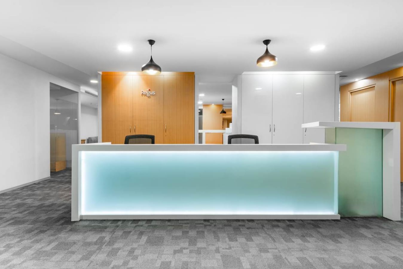Modern reception area with sleek design, ample lighting, and contemporary furnishings. Ideal for welcoming clients.