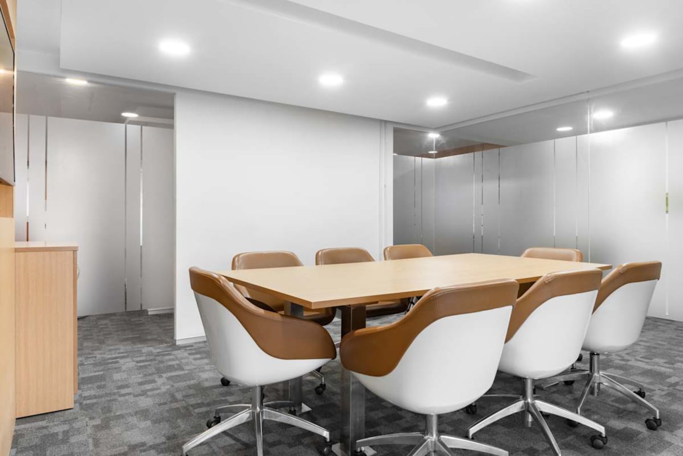 Modern conference room with sleek chairs and a spacious table, ideal for productive meetings.