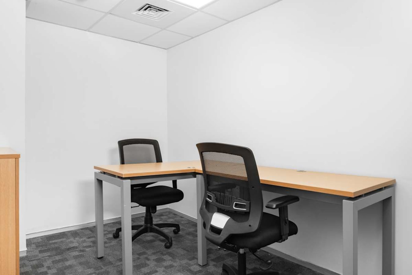 Modern, private office with sleek desks and ergonomic chairs in Telangana coworking space.