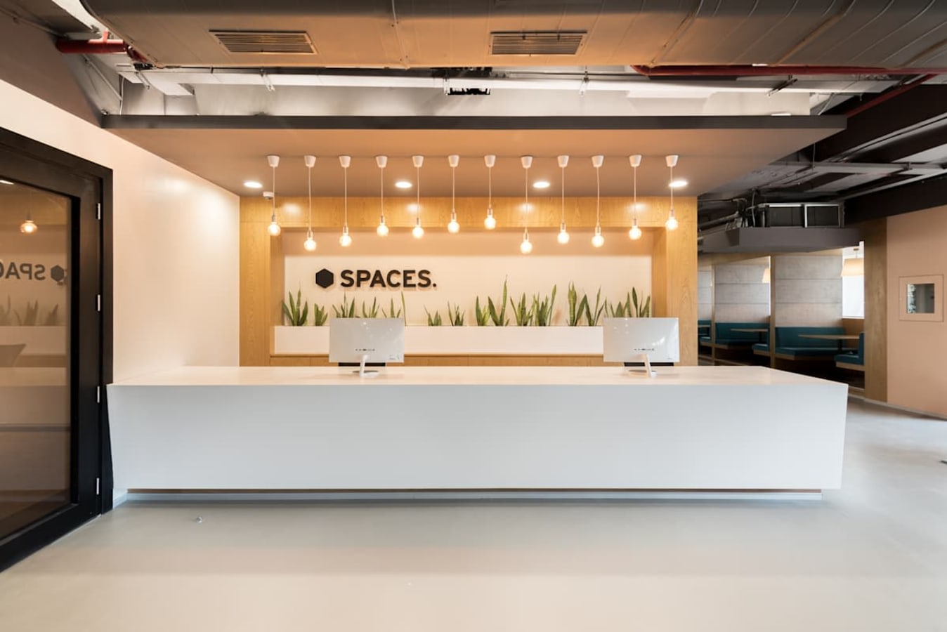 Modern coworking reception area with sleek design and ambient lighting on JP Road.