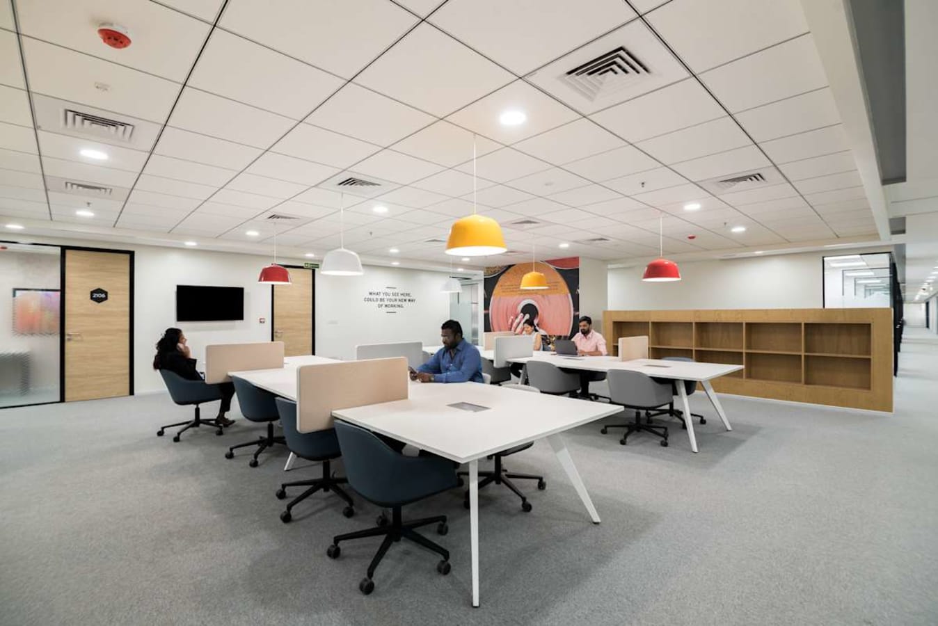 Modern coworking space with open plan, vibrant lighting, and ergonomic seating in JP Road, Maharashtra.