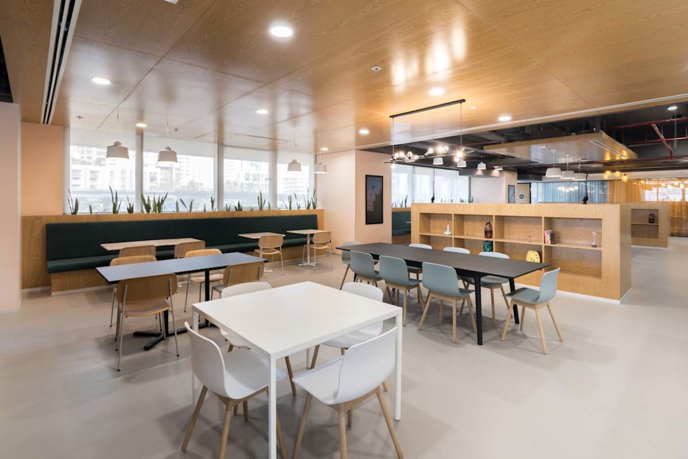 Modern coworking space with versatile seating and ample natural light on JP Road, Maharashtra.