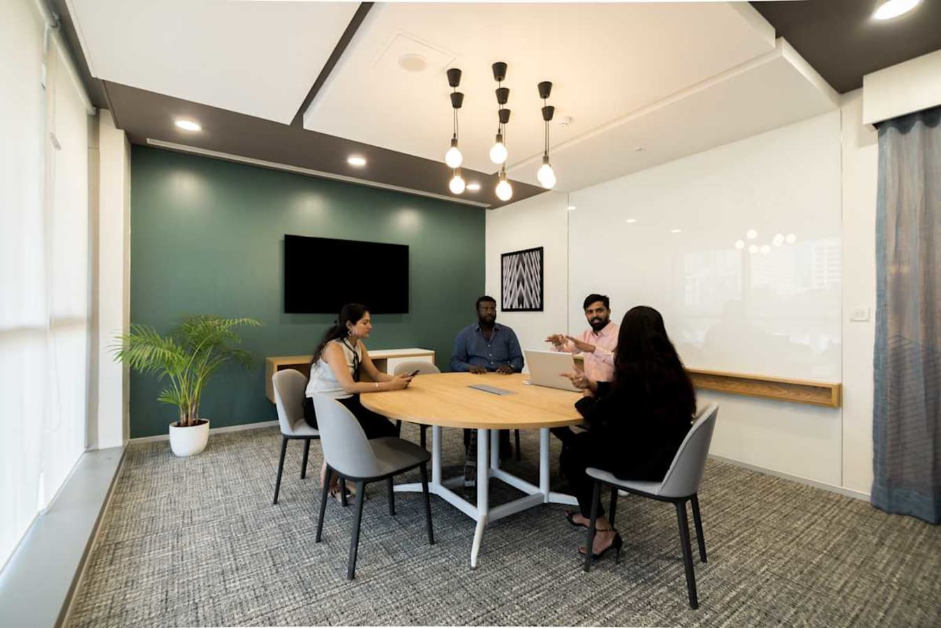 Modern conference room in flexible coworking space with sleek design and natural lighting.