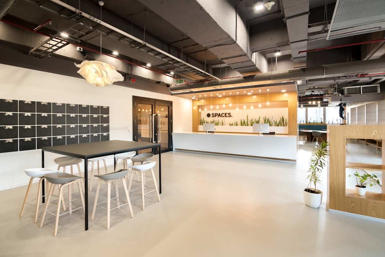 Modern coworking space with open layout, sleek furniture, and ample natural light on JP Road.