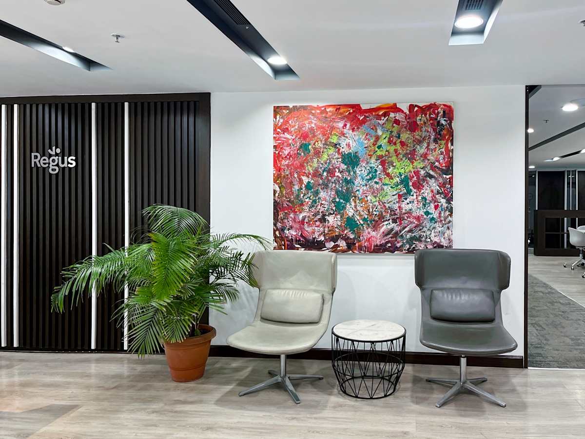 Modern coworking lounge in Gurugram with stylish seating and vibrant artwork.