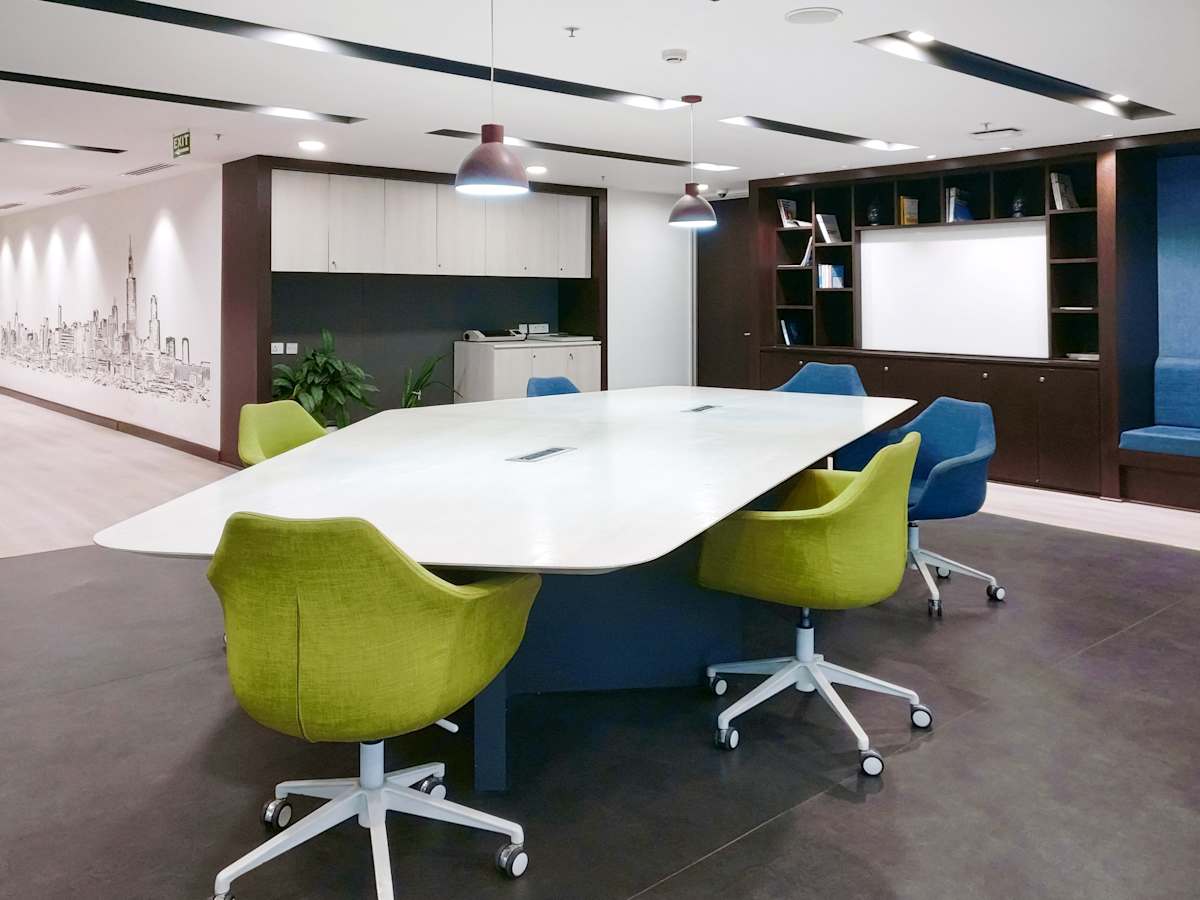 Modern coworking space featuring vibrant seating, ample natural light, and collaborative zones.