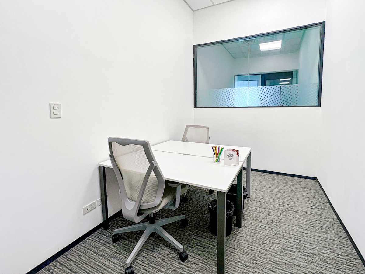 Modern private office with natural light and ergonomic chairs on 5th Avenue, Metro Manila.