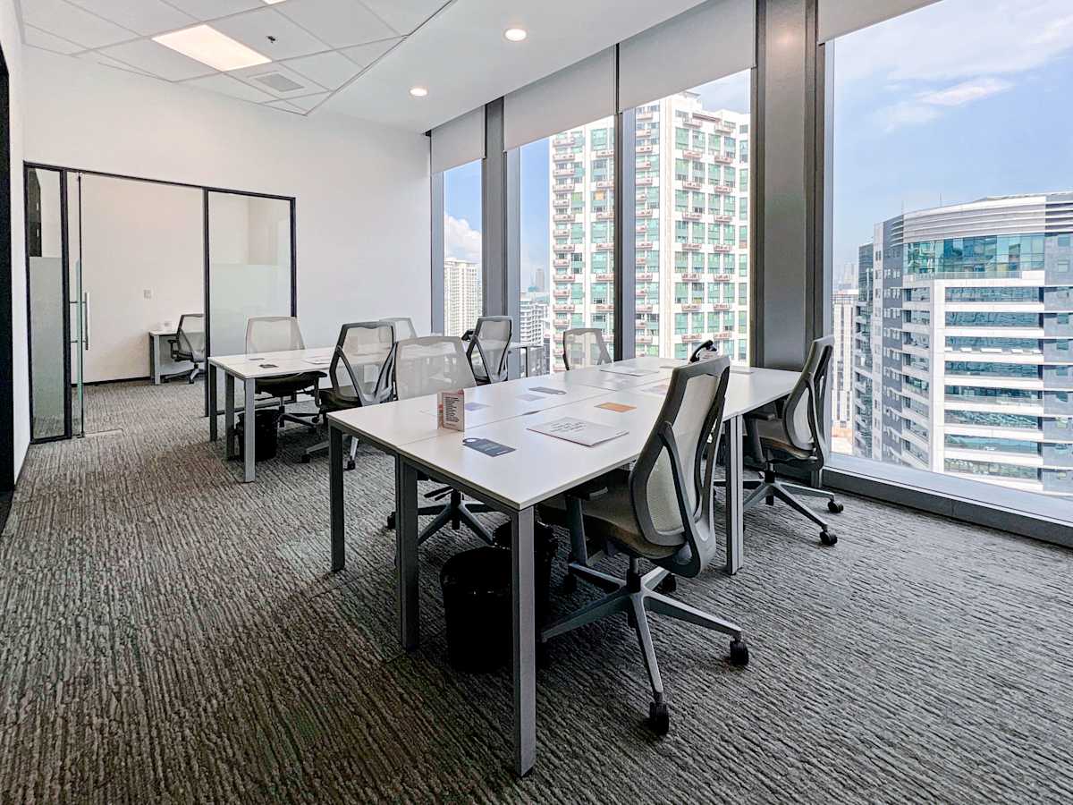 Bright and modern coworking space with city views and ergonomic seating on 5th Avenue, Metro Manila.