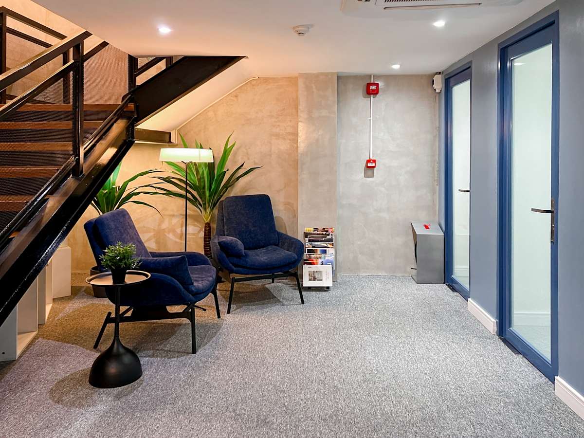 Stylish coworking nook with cozy seating, modern decor, and vibrant lighting on Quezon Ave.