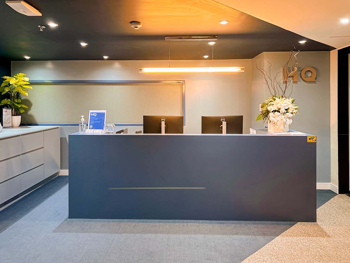 Modern reception area with sleek design, ambient lighting, and welcoming floral accents.