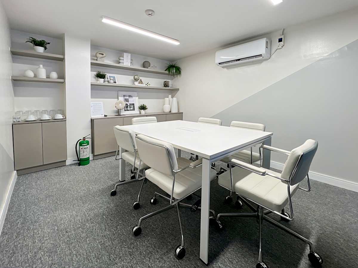 Modern coworking space with sleek furnishings, natural accents, and ample lighting in Quezon Avenue.
