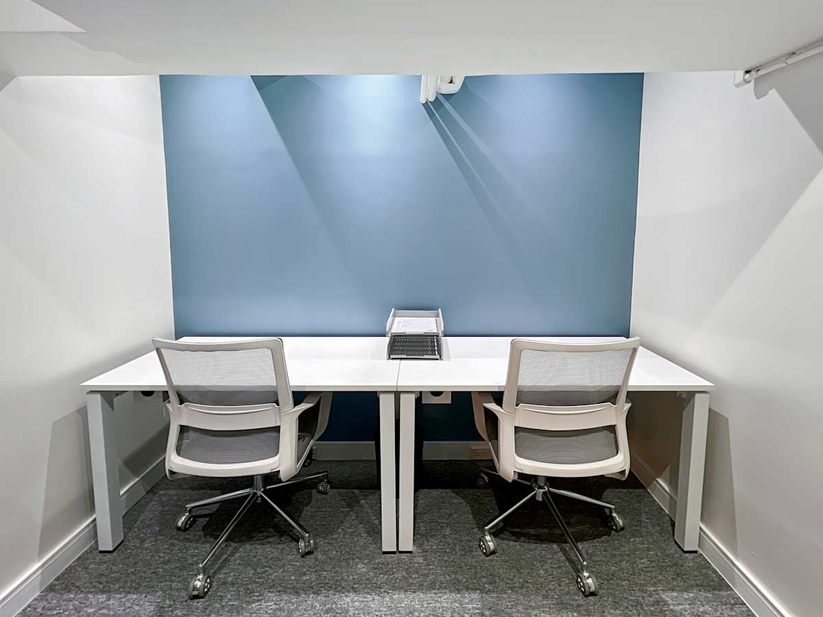 Sleek coworking space with two ergonomic chairs and modern lighting on Quezon Avenue.